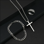 Silver necklace with cross pendant and chain on a dark surface